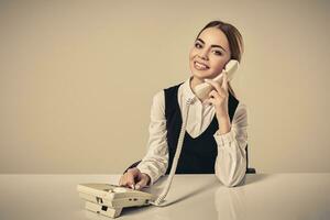 portrait of young secretary answering telephone photo