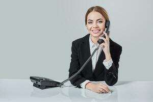 Portrait of young woman sitting at the table and working. photo