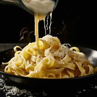 ai generado Fettuccine con parmesano queso siendo vertido sobre negro mostrador foto