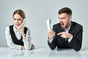 picture of man and woman with telephone at the table photo