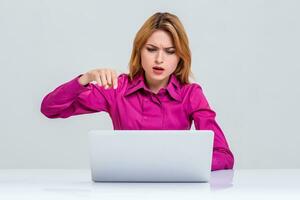 young woman sitting in the table and using laptop photo