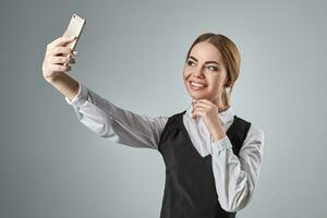 Portrait of young caucasian business woman in suit doing selfie on the phone. photo