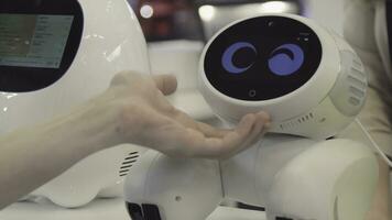 Hand of man touches the robot. Robot is happy with the touch of a human. Technology concept photo