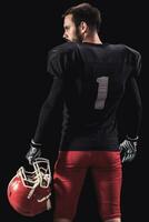 Football player on dark background photo