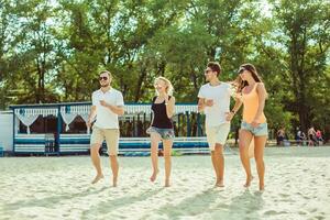 Young funny guys in sunglasses on the beach. Friends together. photo