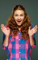 Portrait surprised young brunette woman with wavy hair photo