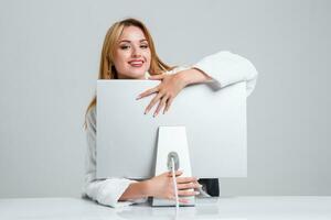 young woman sitting in the table and using computer photo