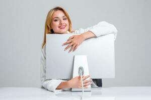 young woman sitting in the table and using computer photo