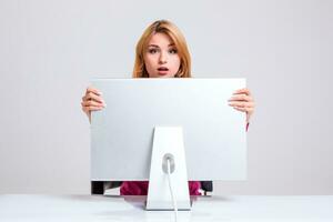 young woman sitting in the table and using computer photo