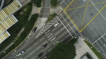 Top view of a city intersection with a bus, cars and people crossing the street. Shot. Traffic at daytime, rossroad in the center of big city, aerial top view. photo