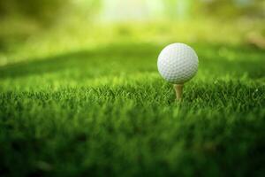 Golf ball close up on tee grass on blurred beautiful landscape of golf background. Concept international sport that rely on precision skills for health relaxation. photo