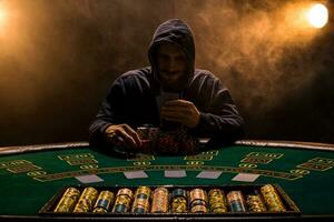 Portrait of a professional poker player sitting at poker table photo