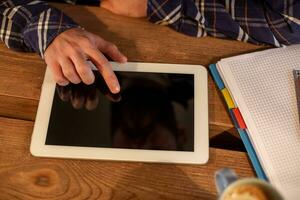 Man using tablet works. White tablet with blank screen in a man hands photo