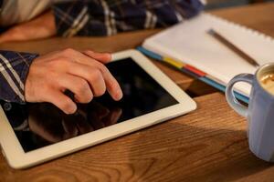 Man using tablet works. White tablet with blank screen in a man hands photo