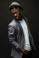 Portrait of a fashionable african american man smiling on black background photo