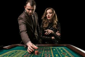 hombre con mujer jugando ruleta a el casino. adiccion a el foto