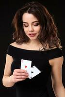 Young woman playing in the gambling on black background photo