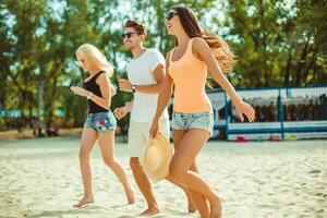 joven gracioso chicos en Gafas de sol en el playa. amigos juntos. foto