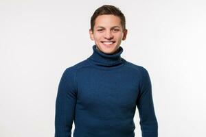 Studio shot of young man wearing blue turtleneck sweater against photo