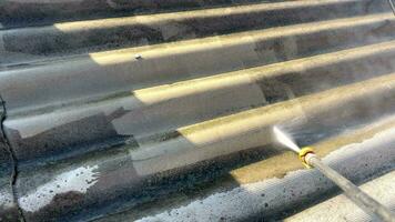 Close- up of water pressure removing dirt. The process of cleaning the roof from many years of layers. Removal of dirt with a pressure washer from the slate roof. video