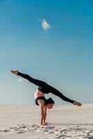 Side view of girl doing squats on grey background photo