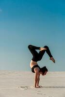 Side view of girl doing squats on grey background photo