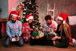 Picture showing group of friends with Christmas presents on party at home photo