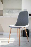 Modern luxury fashion stylish chair with white soft fabric on top and light wooden legs standing, minimal vintage style photo