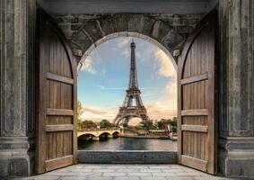 Large wooden door open with Eiffel Tower on Seine River on sunset at Paris photo