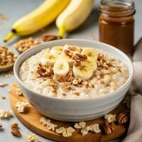 AI generated A bowl of creamy oatmeal with sliced banana, honey, and chopped walnuts photo