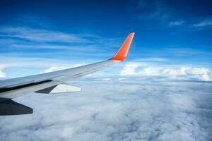 Wing of airplane flying on sky photo