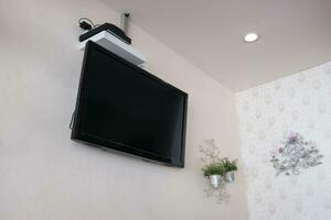 Flat screen tv lcd on wall with decor flower photo