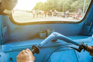 Driving blue tricycle tuk-tuk shining photo