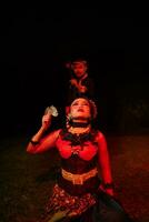 a female dancer in a red costume sat in the silence of the night which strengthened the sadness photo