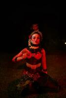 a group of female dancers with faces full of sadness sitting alone in the middle of a field photo