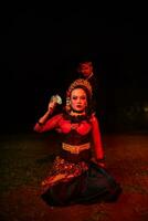 a group of female dancers with faces full of sadness sitting alone in the middle of a field photo