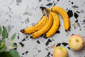 Ripe Bananas and Apples on Terrazzo photo