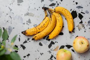 AI generated Ripe Bananas and Apples on Terrazzo photo