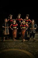 a group of dancers standing very proud and happy after finishing performing on stage photo