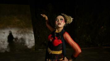 an Indonesian dancer with facial expressions that radiate beauty and happiness dances and captivates the audience photo