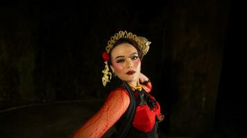 an Indonesian dancer shows a dance that shows the beauty of a tradition full of stories in every movement photo