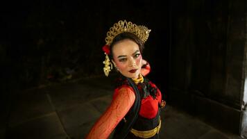 an Indonesian dancer shows a dance that shows the beauty of a tradition full of stories in every movement photo