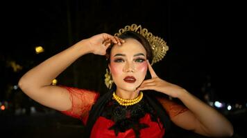 An Indonesian dancer becomes an ambassador of cultural beauty and elegance by dancing on stage photo