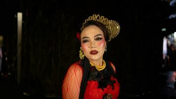 An Indonesian dancer becomes an ambassador of cultural beauty and elegance by dancing on stage photo
