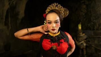 an Asian dancer poses very beautifully while standing in the castle photo