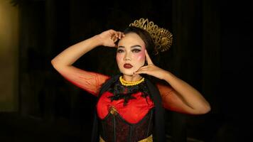 An Indonesian dancer becomes an ambassador of cultural beauty and elegance by dancing on stage photo