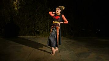 an Asian dancer poses very beautifully while standing in the castle photo