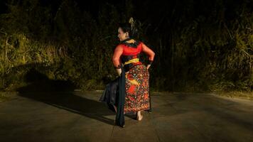 an Indonesian dancer looks full of enthusiasm and shows his courage to move and dance photo