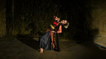 a Javanese dancer in a red costume presented a dance that captivated the audience with his skill photo