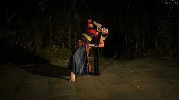 a Javanese dancer in a red costume presented a dance that captivated the audience with his skill photo